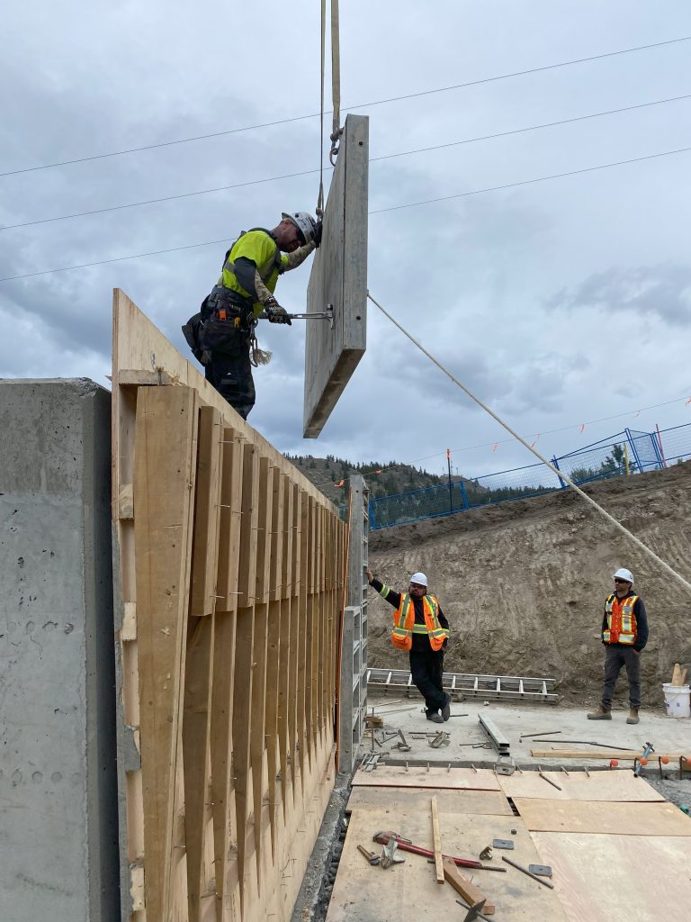 Concrete slabs being put into a wall.